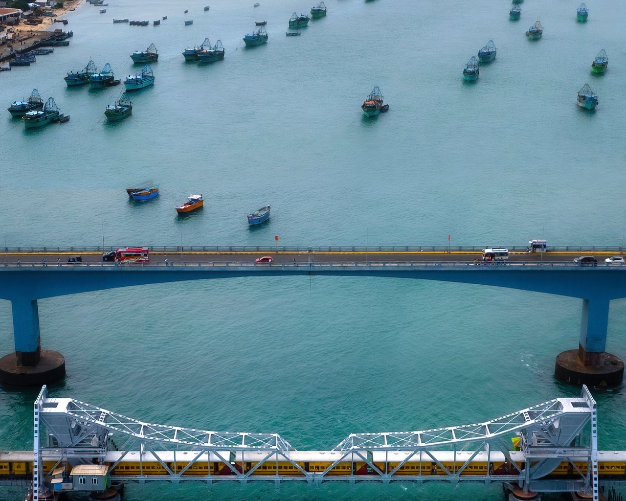 Aerial view of a fishing harbour and bridge at first light, Kerala